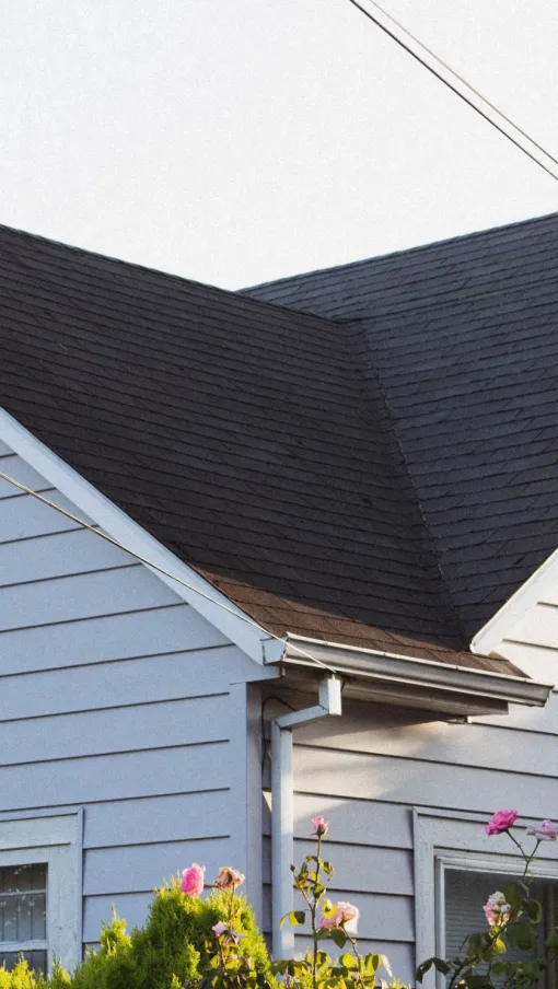 a house with a fence and flowers
