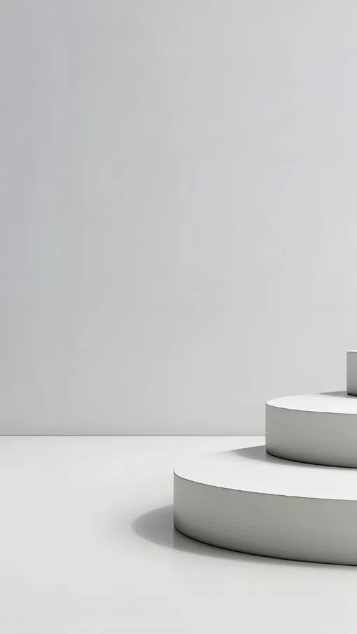 Woman standing on top of a large white three-tiered circular platform in a minimalist white room.