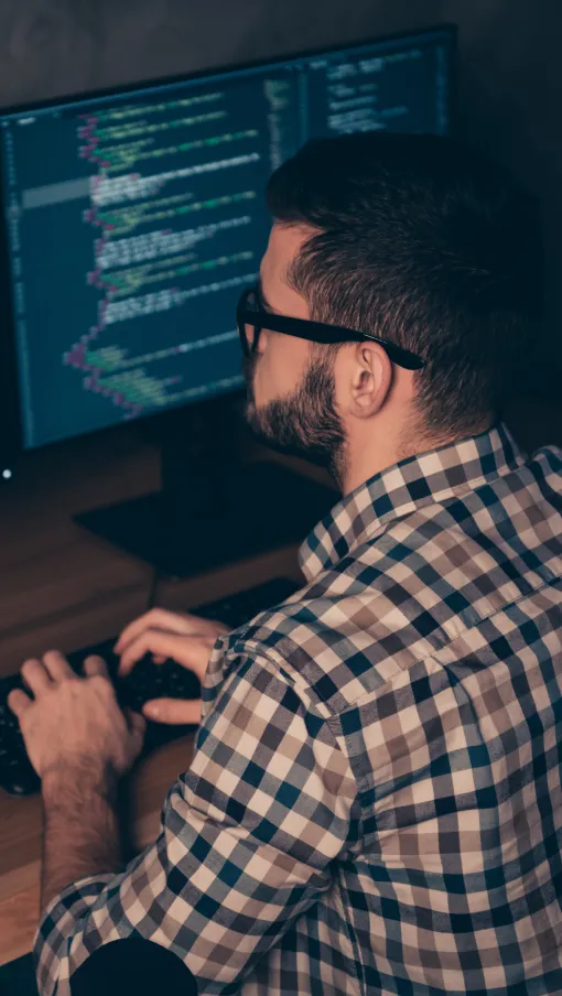a man coding on a screen