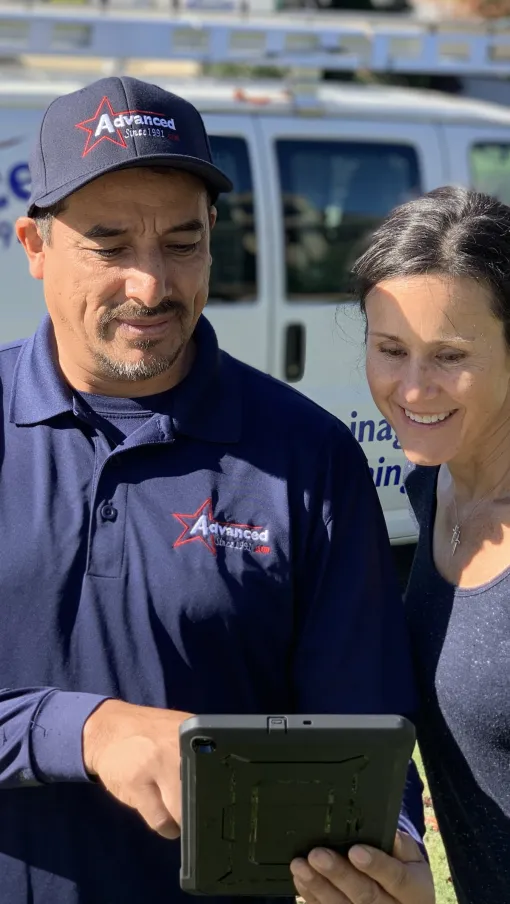 a man and a woman holding a tablet