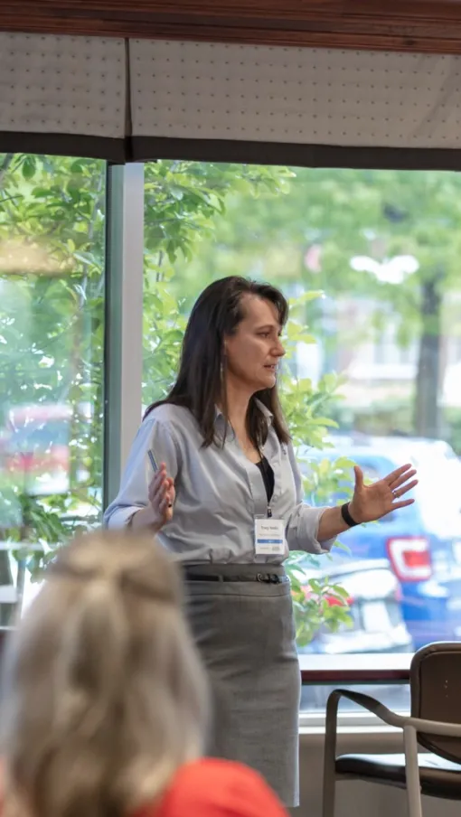 a person speaking to a group of people