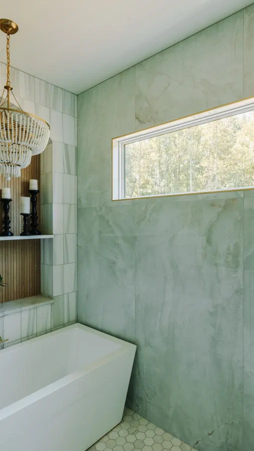 a bathtub and a shower in a bathroom with a picture window with energy efficient low e coating