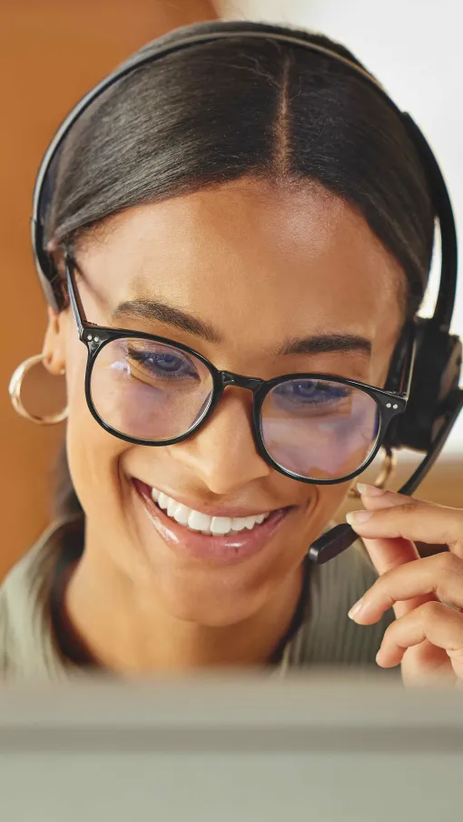 a person wearing glasses and smiling