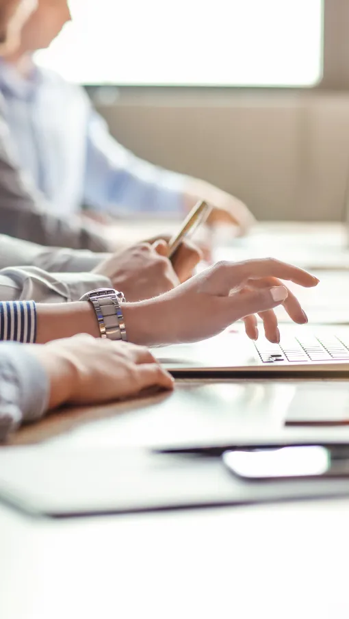 a man and a woman working on a laptop