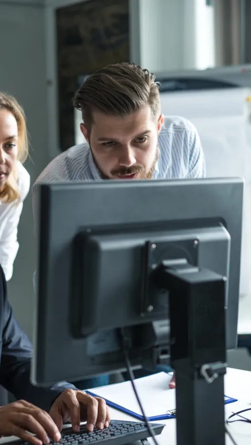 a group of people looking at a computer screen
