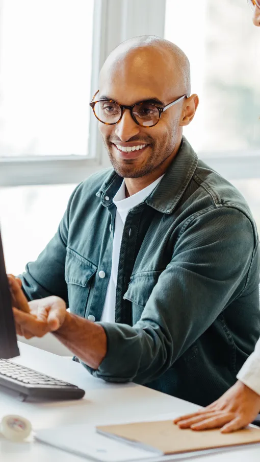 a man and a woman looking at a computer screen