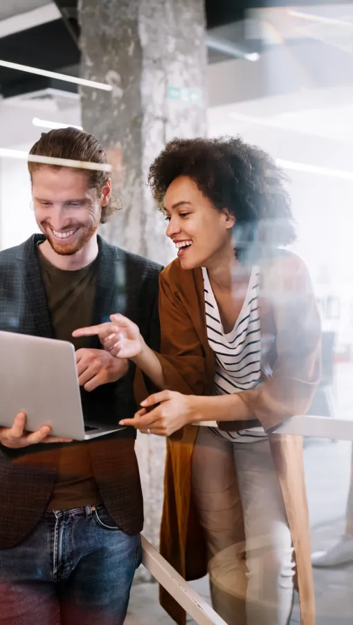 a group of people looking at a laptop