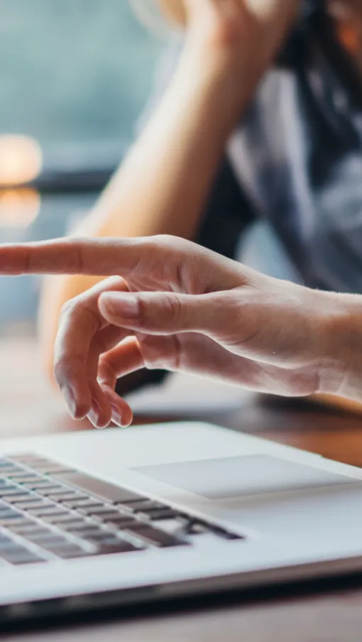 a man and a woman working on a laptop