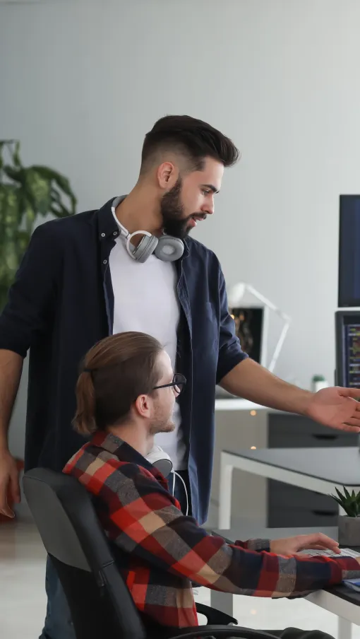 a man showing a woman something on the computer