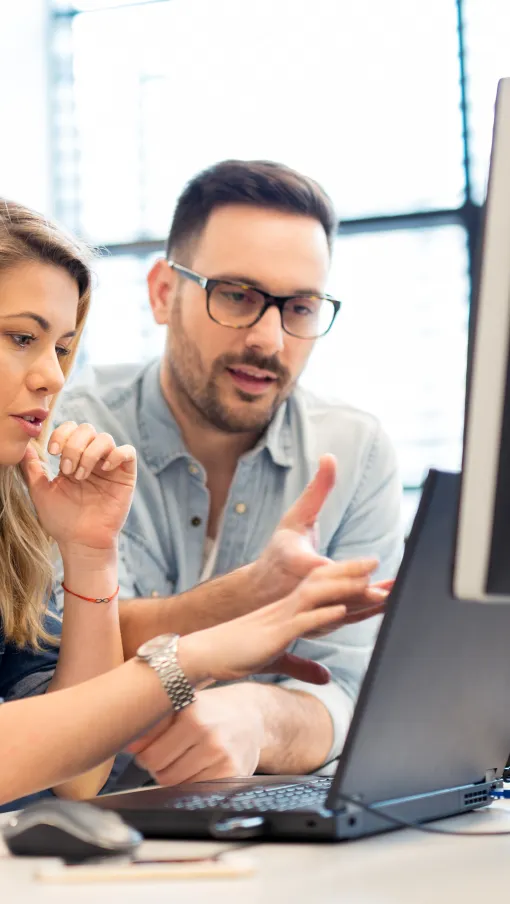 a group of people looking at a computer screen