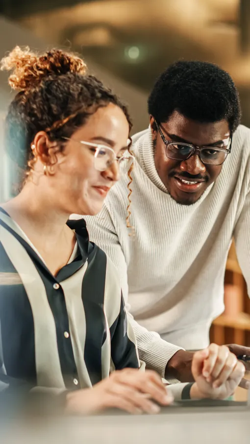 a few people looking at a laptop