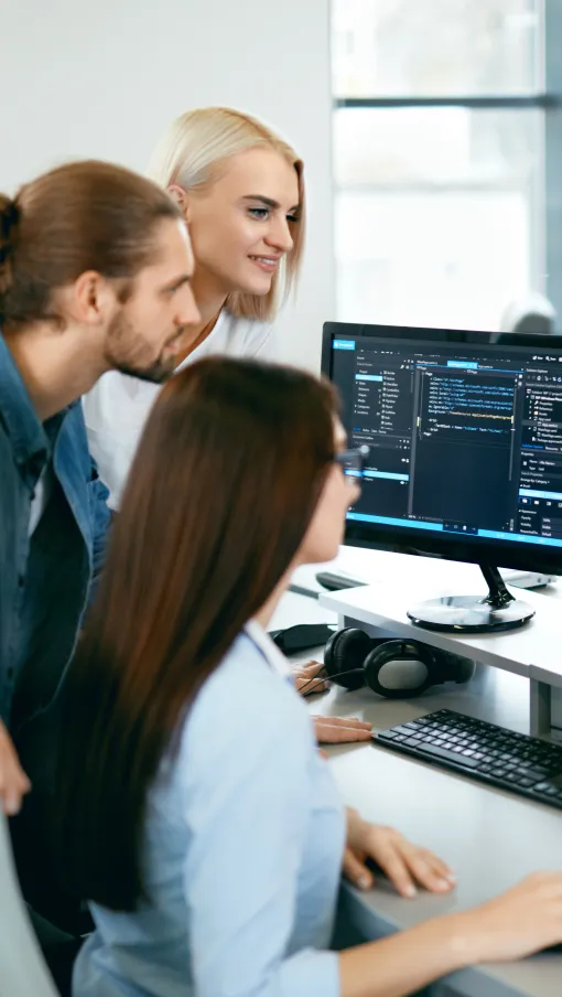 a few people working at a computer