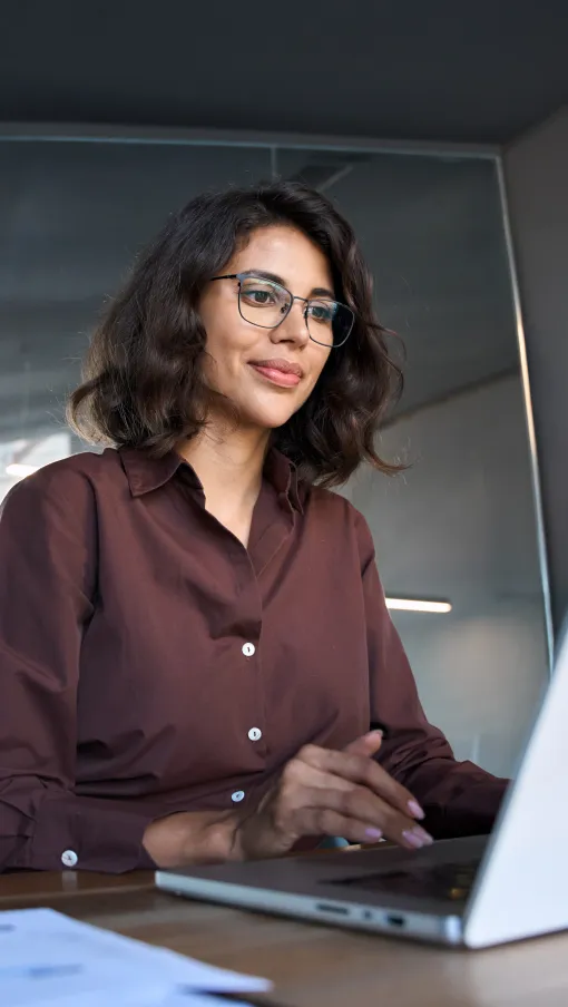 a person sitting at a desk with a laptop