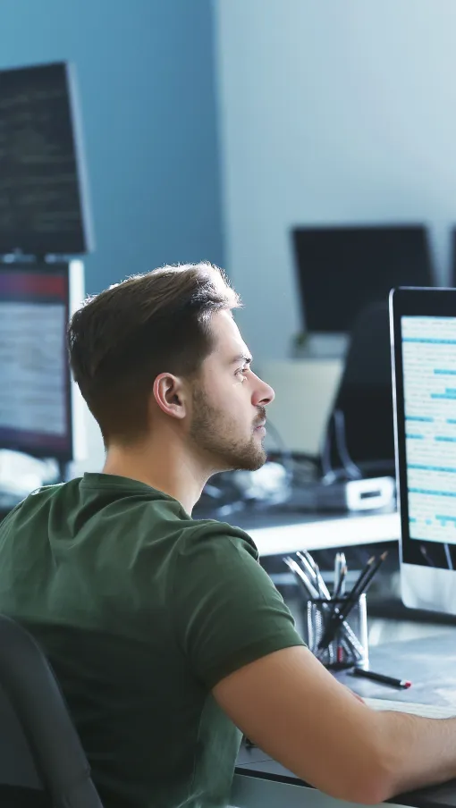 a person sitting at a desk with a computer