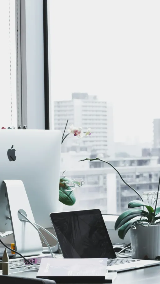 a desk with a computer and other office items