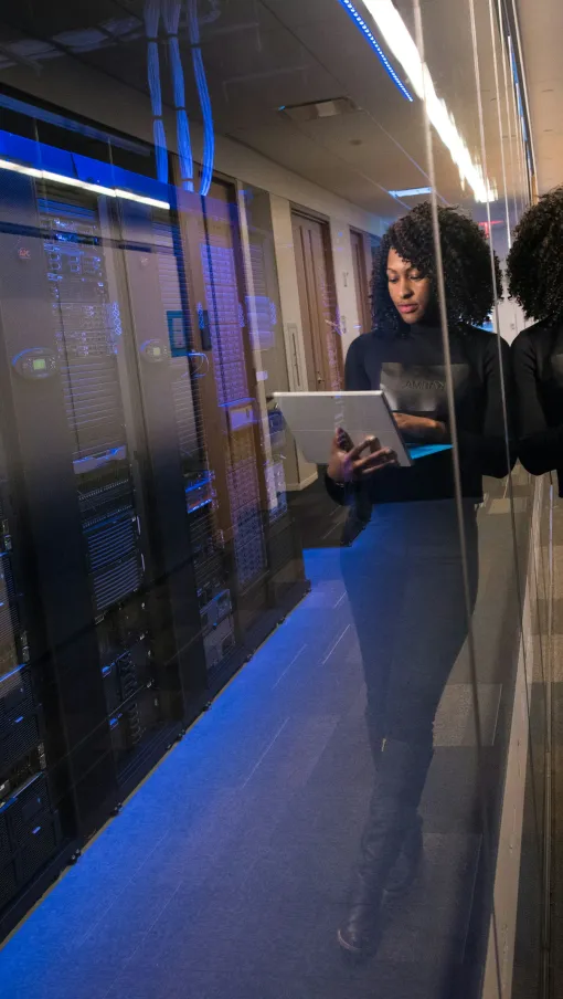 a few people working in a server room