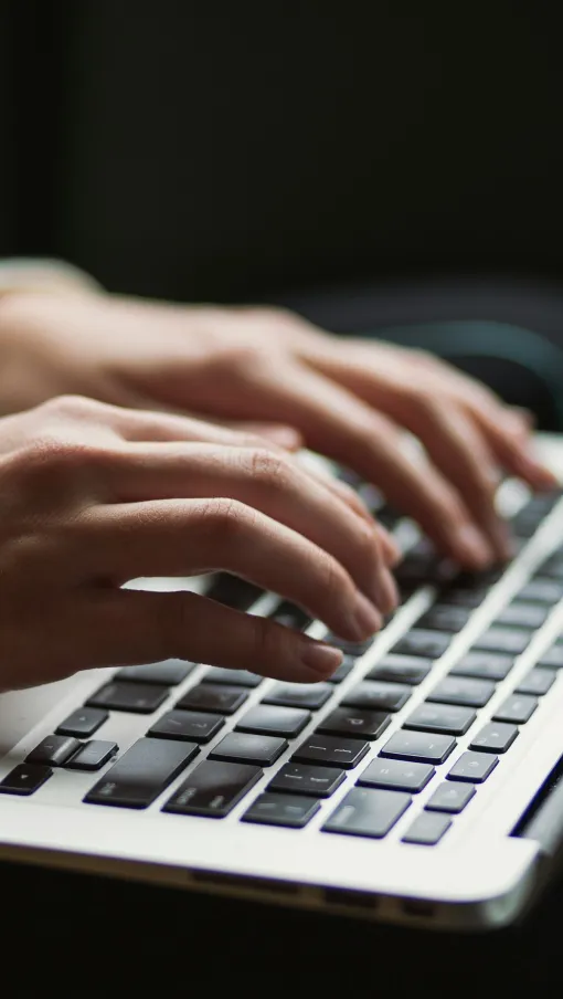 a person typing on a laptop