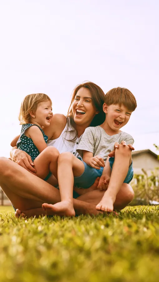 a group of children sitting on grass