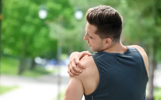 a person holding their shoulder