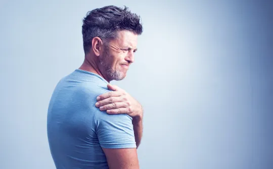 a man with his hand on his shoulder