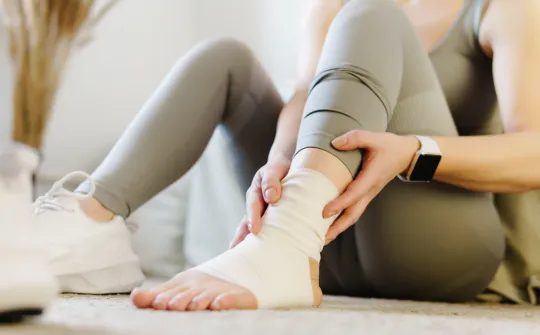 a woman with her ankle wrapped
