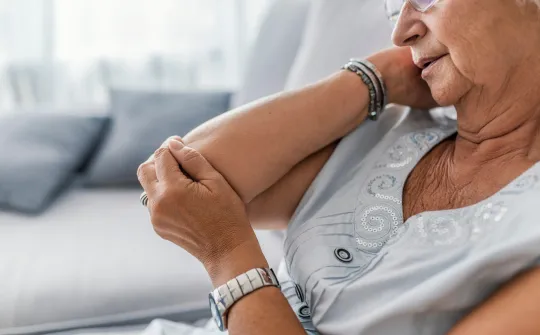 a woman holding her elbow