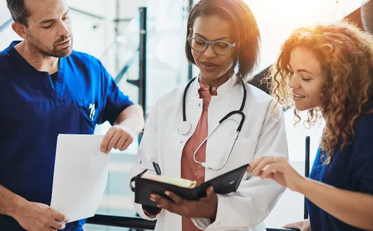 a doctor showing a patient something on the tablet