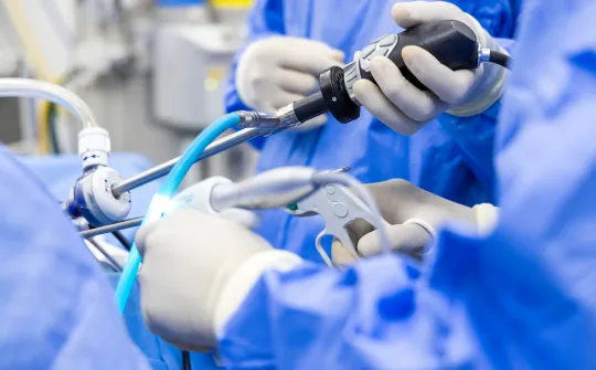 a person in a blue lab coat