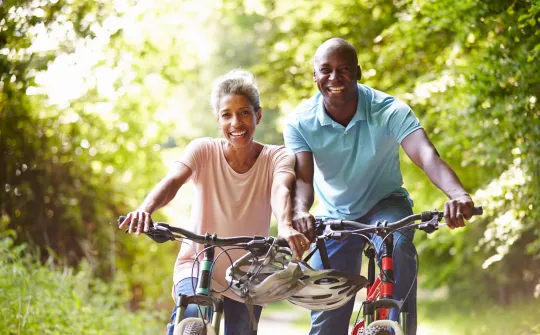 a man and woman riding bikes