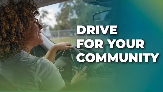 Smiling woman driving a car with text Drive for Your Community beside her in bold white letters.
