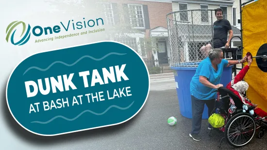 Person in wheelchair and volunteer at dunk tank event hosted by OneVision promoting inclusion and fun outdoors