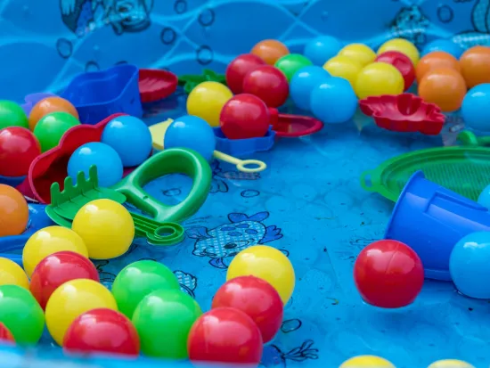 a group of colorful balls floating in a kiddie pool