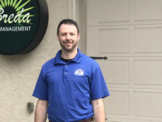 a man standing in front of a blue wall