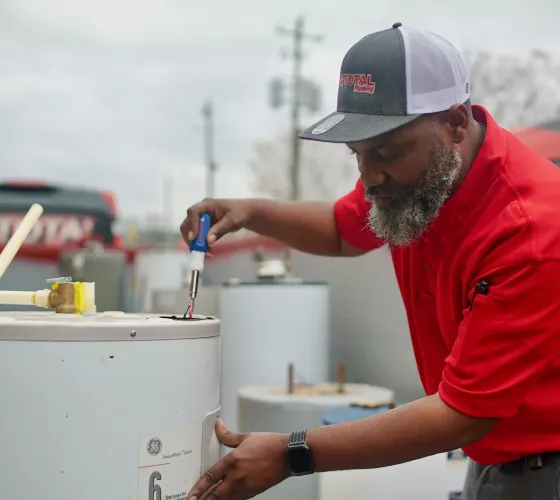 A-Total Plumbing Technician Working on a Water Heater
