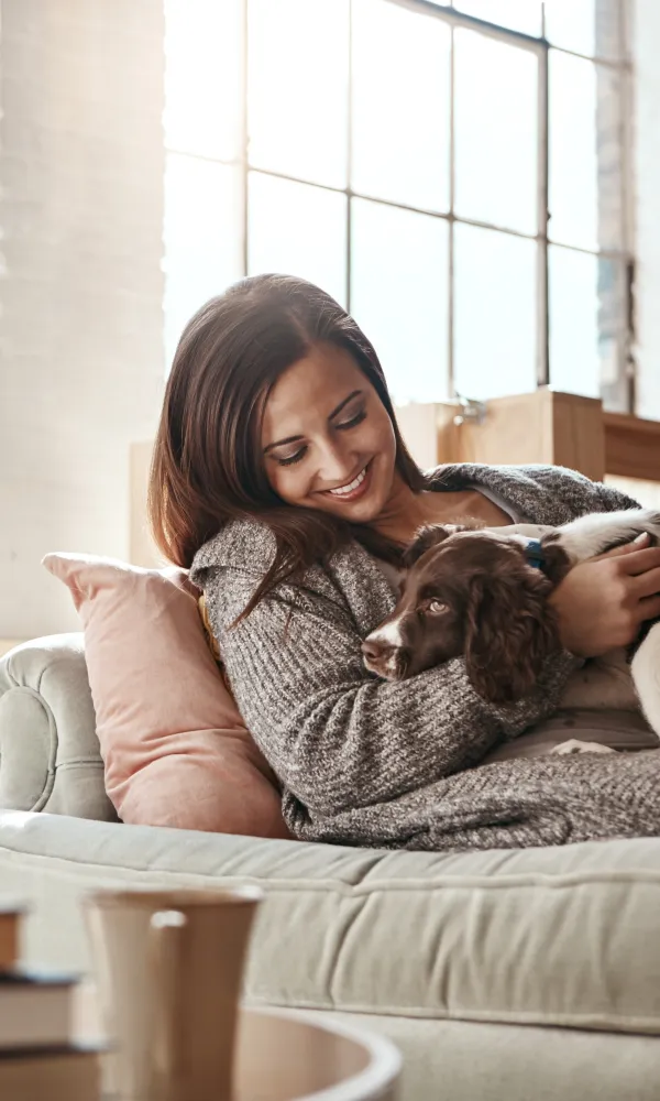 a woman holding a dog