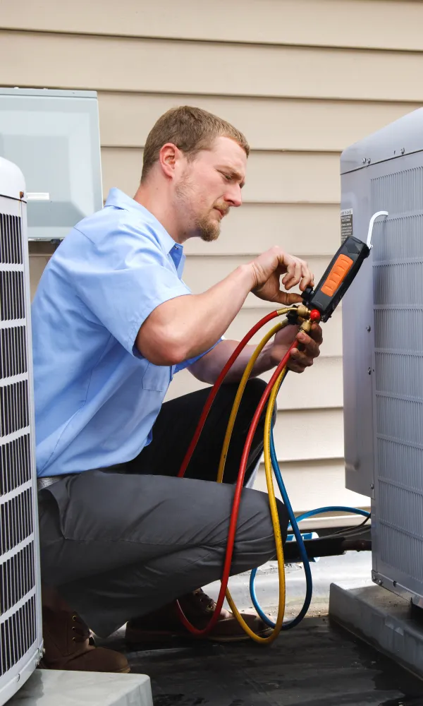 a man fixing air conditioner in Pittsburgh, Pa