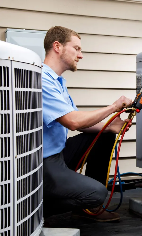a man fixing a Pittsburgh, PA Carrier Air Conditioner Unit