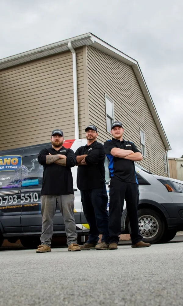 a group of men standing in front of a truck