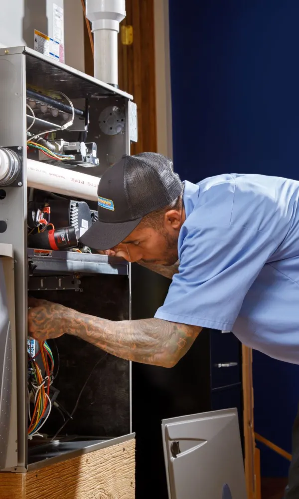a man working on a gas furnace