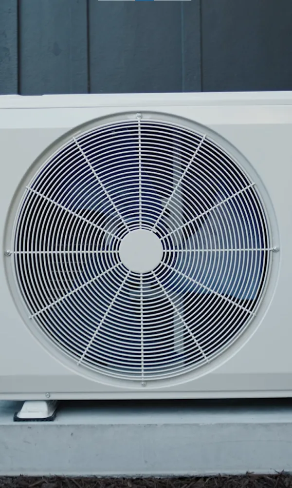a white fan on a stand outside