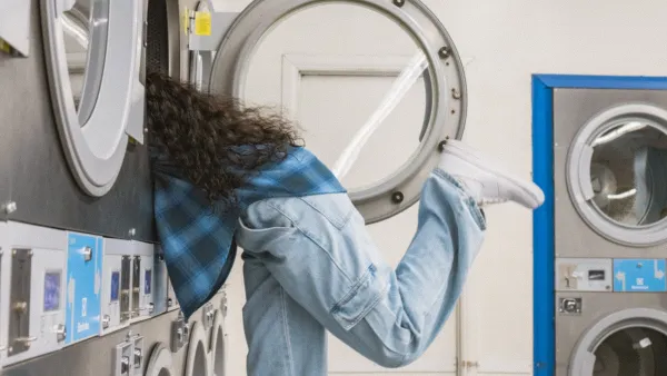 a man in a blue coat in a laundry room