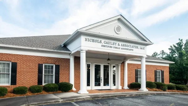 Brick office building with white columns and sign reading Nichols, Cauley & Associates, LLC Certified Public Accountants.