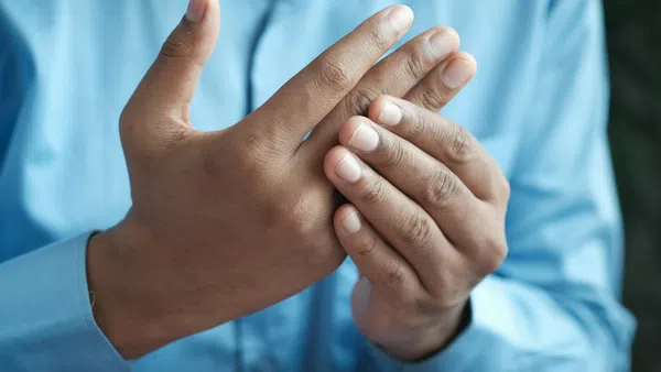 a person's hand holding a thumb up