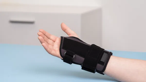 a hand holding a black watch