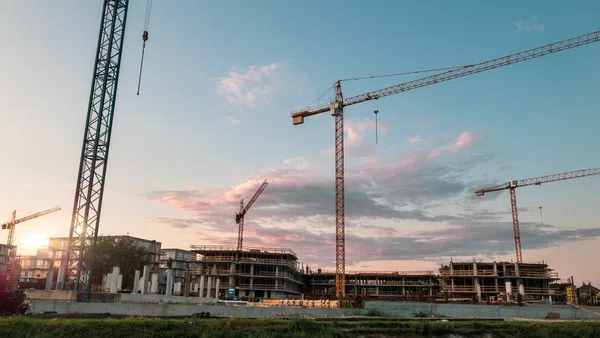 large construction equipment around a building
