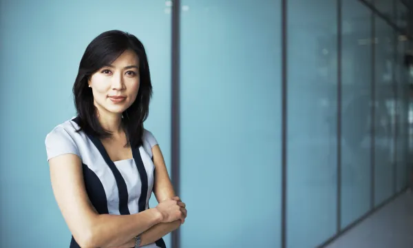 a woman standing in front of a blue wall