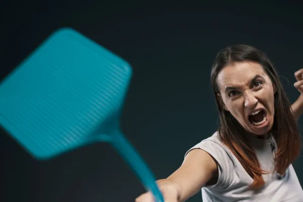 woman swatting a flyswatter