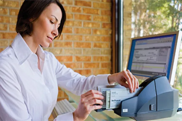 woman using remote deposit scanner