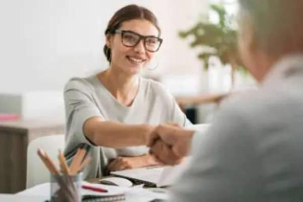 woman shaking hands with banker