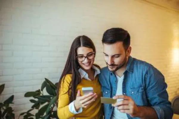 man and woman paying for a mobile purchase with debit card